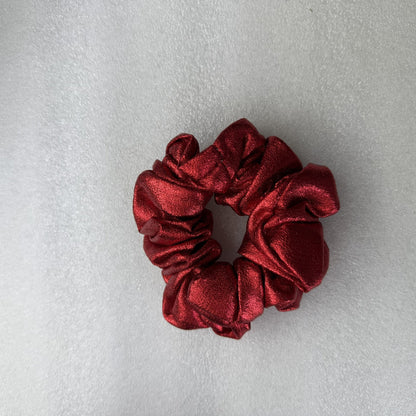 Red scrunchie on a light gray background